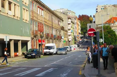 a busy city street with cars and people on the sidewalk at SP199 Flat in Porto