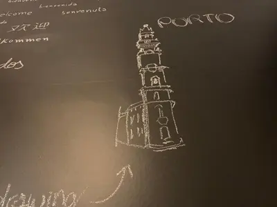 a drawing of a clock tower on a blackboard at SP199 Flat in Porto