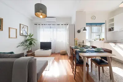 a living room with a dining room table and a kitchen at SP199 Flat in Porto