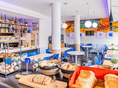 a bakery with bread and pastries on a counter at Hotel ibis Budget Porto Gaia in Vila Nova de Gaia