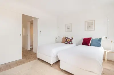 a bedroom with two beds and a couch at Gaia Retreat • 2 BD · A/C in Vila Nova de Gaia