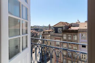 a living room with a couch and a stone wall at LovelyStay - Sao Domingos Apartment in Porto