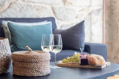 a kitchen and living room with a glass table and chairs at LovelyStay - Sao Domingos Apartment in Porto