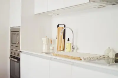 a kitchen counter with a sink and a sink at Elisa Apartment in Porto