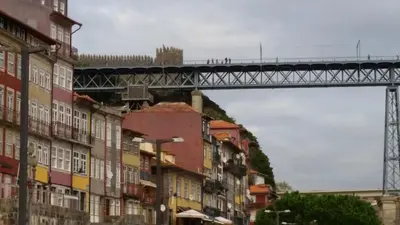 a bridge with a train on it over a city at Historic Oporto Apartment at oporto UNESCO area, in front of Porto Wine caves in Porto