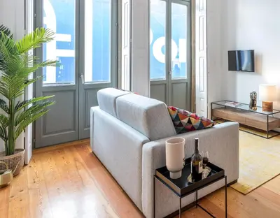 a living room with a couch and a table at Apartamentos Villa Bolhao in Porto