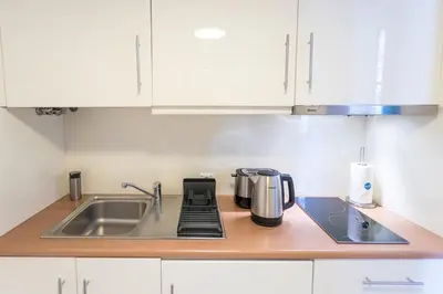a kitchen counter with a sink and a coffee maker at Apartamentos Villa Bolhao in Porto