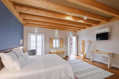 a bedroom with a white bed and wooden ceilings at YOUROPO - ExtendALL in Porto
