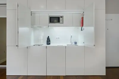 a white kitchen with a sink and a microwave at YOUROPO - ExtendALL in Porto