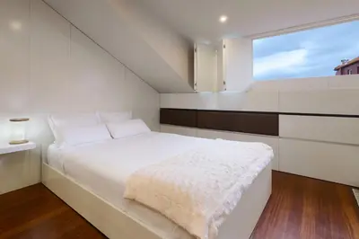 a white bed in a room with a large window at YOUROPO - ExtendALL in Porto