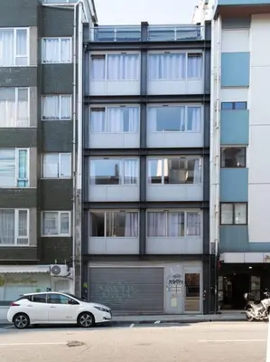 a white car parked in front of a building at Marquês Deluxe Apartment in Porto