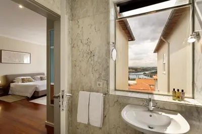 a bathroom with a sink and a window at Casas Da Formiga - Riverview Terrace and Pool in Porto