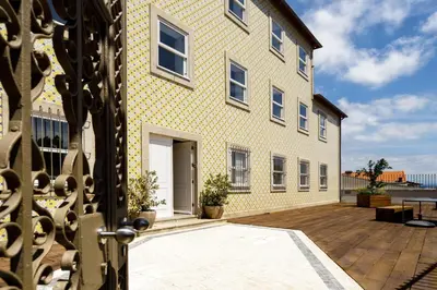 an external view of a building with a patio at Casas Da Formiga - Riverview Terrace and Pool in Porto
