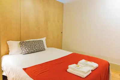 a bedroom with a bed with towels on it at APOSENTUS - Charming Center Apartment with Balcony in Porto