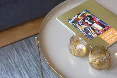 a plate with two candles and a magazine at Casa D'ouro in Porto