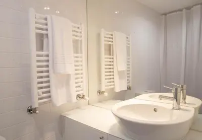 a white bathroom with a sink and a mirror at PORTO CONCEPT HOME - Paranhos in Porto