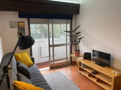 a living room with a couch and a television at Casa dos Azulejos in Porto