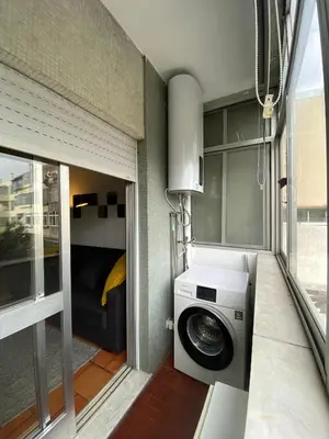 a washing machine in a small room with a window at Casa dos Azulejos in Porto