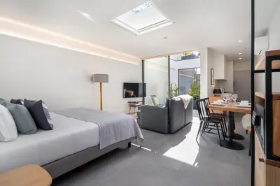 a bedroom with a bed and a dining room at Canto De Luz - Luxury Maison in Porto