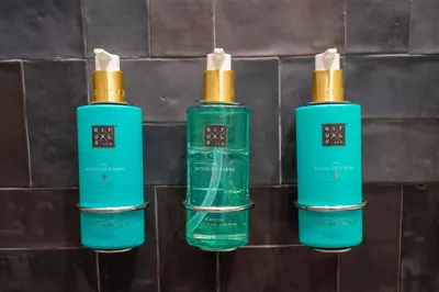 a trio of three green bottles on a wall at Canto De Luz - Luxury Maison in Porto