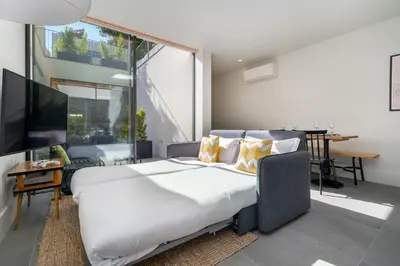 a bedroom with a large bed and a large window at Canto De Luz - Luxury Maison in Porto