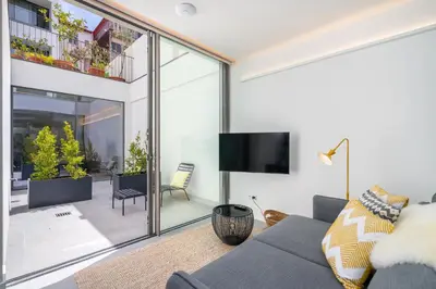 a living room with a couch and a tv at Canto De Luz - Luxury Maison in Porto