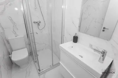 a bathroom with a shower and a toilet and a sink at Downtown 3 Bedroom with Balcony - Quiet Street - Family Friendly - Groups in Porto