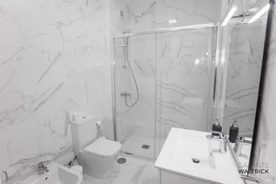 a bathroom with a shower and a toilet and a sink at Downtown 3 Bedroom with Balcony - Quiet Street - Family Friendly - Groups in Porto