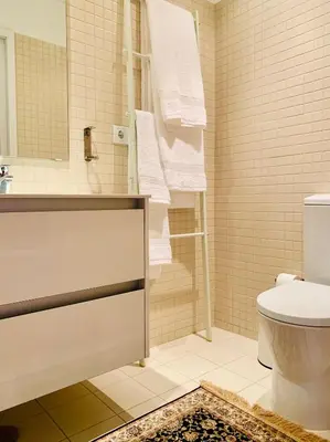 a bathroom with a toilet and a shower with towels at Oporto Chic&Cozy - Santo Ildefonso in Porto