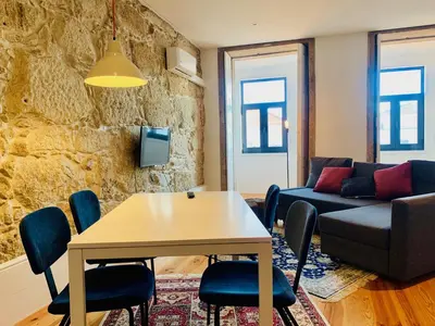 a living room with a table and a couch at Oporto Chic&Cozy - Santo Ildefonso in Porto