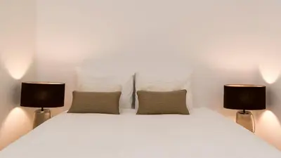 a living room with a couch and a table at Casa Oliveira in Porto