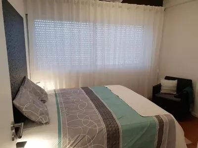 a bedroom with a bed in front of a window at Porto Central City Heart I & II in Porto
