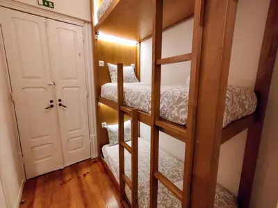 a room with three bunk beds and a door at Sweet Swell in Porto