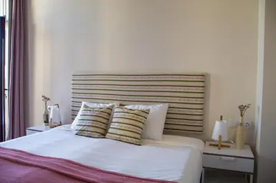 a bedroom with a white bed with two pillows at Sweet Swell in Porto