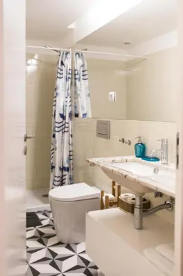 a bathroom with a sink and a toilet and a shower at VIVA Breiner Flats in Porto