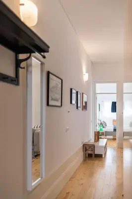 a living room with white walls and wooden floors at VIVA Breiner Flats in Porto