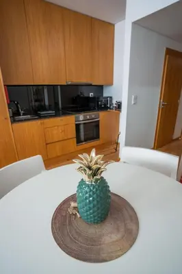 a pineapple sitting on a table in a kitchen at Downtown Porto Relaxed Apartment with Private Yard in Porto