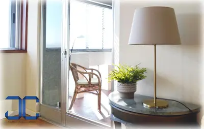 a room with a table with a lamp and a chair at Pardal Apartment by JC in Porto