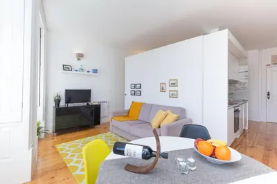a living room with a couch and a table at Host Wise - Colorful Stunning Sunlit Flat in Porto