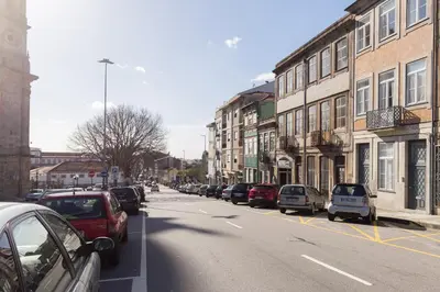 a street with cars parked on the side of the road at Host Wise - Colorful Stunning Sunlit Flat in Porto