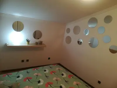 a bedroom with a bed with flowers on the wall at Oportobestview-TopFlat in Porto