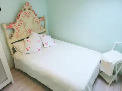 a bedroom with a white bed and a chair at Cor Iesu House, Arts Quarter, Porto in Porto