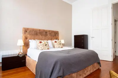 a bedroom with a large bed with white sheets and pillows at LovelyStay - Aurora Heights Apartment in Porto