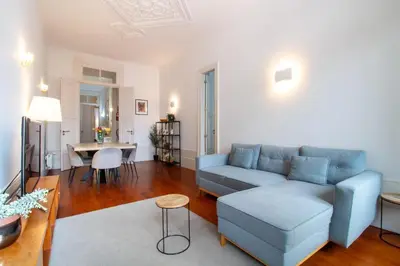 a living room with a blue couch and a table at LovelyStay - Aurora Heights Apartment in Porto