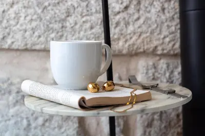 a table with a cup and a book and a coffee mug at LovelyStay - Aurora Mezzanine in Porto
