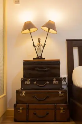 a lamp sitting on top of a stack of suitcases at Casa Sá Noronha Old Town in Porto