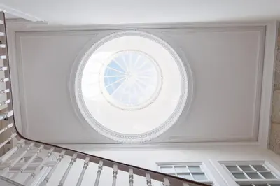 a round window in the ceiling of a staircase at Host Wise - Charming Flat with Netflix - River View in Porto