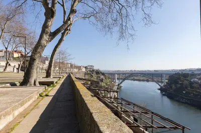 a view of a river with a bridge in the background at Host Wise - Charming Flat with Netflix - River View in Porto
