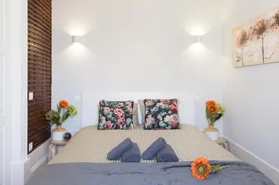 a bedroom with a bed with blue pillows at Host Wise - Charming Flat with Netflix - River View in Porto
