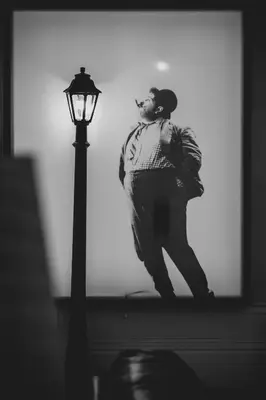 a man standing next to a street light at viterbo'8 - The Artists House in Porto